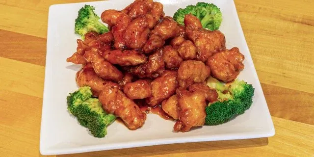 Orange chicken with broccoli on a white plate at Mo’s Chinese #2